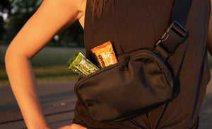 Picture of a person with the Trail Mix and Almond Salted Caramel Honeybar snack bars peaking out of their bag.